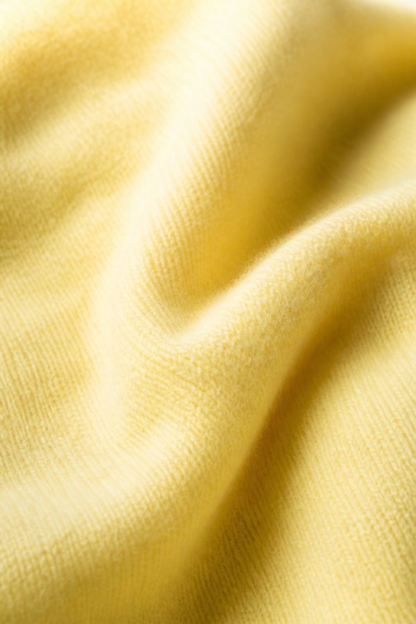 Macro detail of a brushed butter-soft knit in cream